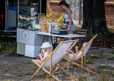 children outside in beach chairs eating ice cream